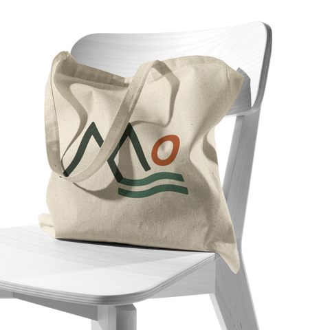 Mountains_Community_Health_Logo_Mark_-_T_CottonTote_S_Chair_AS_Mockup.png_16044550