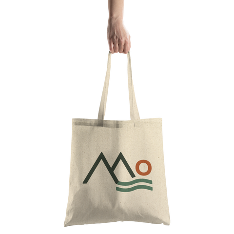 Mountains_Community_Health_Logo_Mark_-_T_CottonTote_S_HandTransparent_Mockup.png_16044549